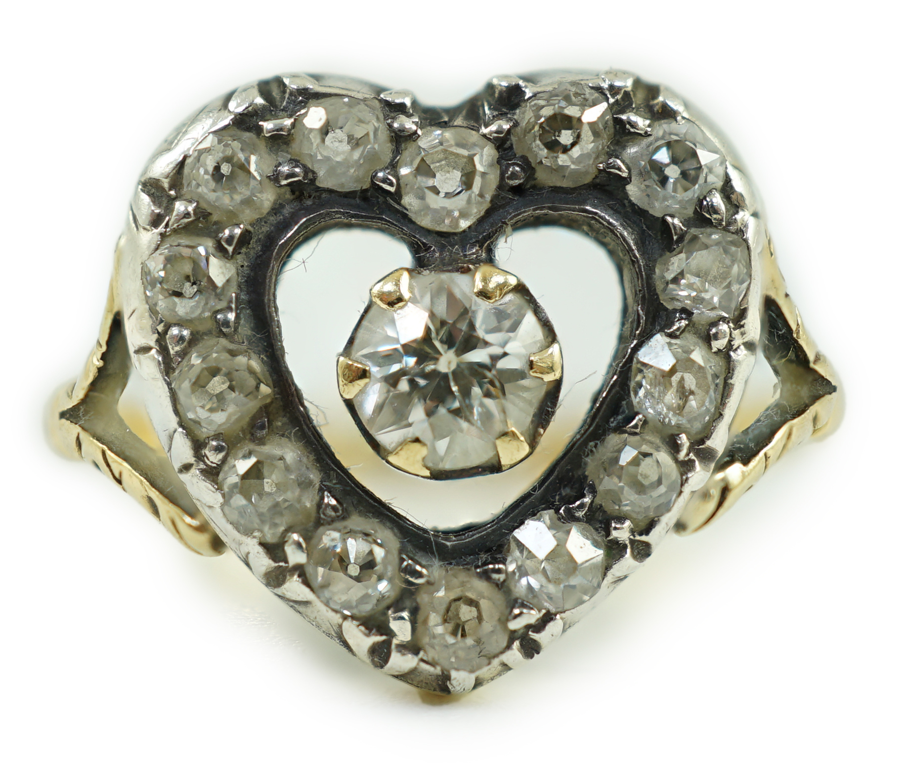 An antique gold and diamond set heart shaped open work cluster ring